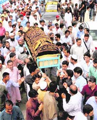 People carry the caskets of victims of Wednesday's plane crash during a funeral prayer in Karachi, Pakistan, on Thursday. The Airbus A321 operated by local carrier Airblue crashed into the hills overlooking the country's capital, Islamabad, killing all 152 persons on board.