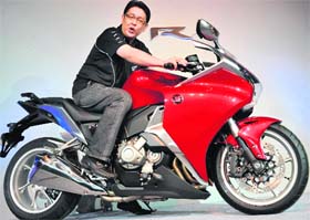 President and CEO of Honda Motorcycle and Scooters India Shinji Aoyama poses with sports bike VFR1200F at its launch in New Delhi on Friday. The bike, which has a 1237 cc liquid cooled compact V4 engine, is priced at Rs 17.5 lakh. 