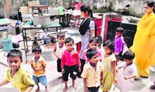 Children walk out of the Community Centre, with containers and sewing machines scattered out in the sun at the Palsora Centre on Friday after the municipal corporation forced them out of the centre.