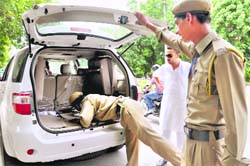 Securitymen check vehicles at the entrance to Panjab University in Chandigarh on Friday.