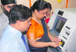 Anuradha Mohit, Director, National Institute of Visually Handicapped (NIVH), inaugurates the first biometric ATM installed by Punjab National Bank at the institute
