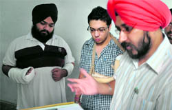 Assault victim Harmanjit Singh (left) and his friend Jasdeep Singh in Ludhiana on Friday.