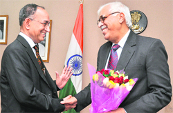Newly appointed Chief Election Commissioner SY Qureshi (R) is greeted by Election Commissioner VS Sampath at his office in New Delhi 