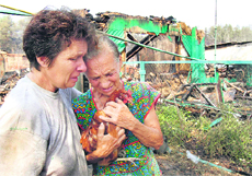 Women mourn the loss of their homes on the outskirts of the Russian city of Voronezh on Friday.