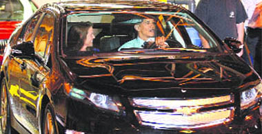 US President Barack Obama, accompanied by assembly manager Teri Quigley, gets behind the wheel of the new Chevy Volt, during his tour of the General Motors plant in Hamtramck, Mich., on Friday. This is the plant where the Volt, an electric car, will be assembled.