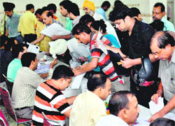 Taxpayers queue up at a special counter set up by the income tax department at Rajasthan Bhavan in Sector 33 on the last day of filing returns.
