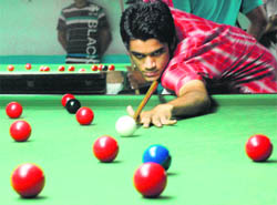 A snooker player in action during the Haryana State Ranking Championship in Panchkula on Saturday.