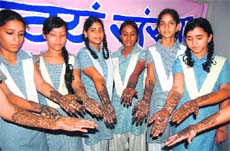 Students take part in a mehndi competition at Phoolchand Narishilp Mandir Girls Inter College in Dehradun on Saturday. 