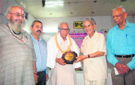Radha Krishan Kukreti being presented an award in Dehradun on Saturday.