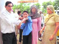 Family members of Satwinder show his broken arm in Gharaunda in Karnal on Saturday. 