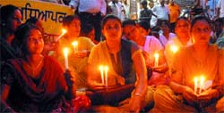 Members of the ETT Teachers Union, Punjab, hold candlelight protest in front of Local Bodies Minister Manorajan Kalia's house in Jalandhar on Saturday