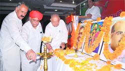 (From left) State BJP president Shamsher Singh Manhas along with party MLA Ashok Khajuria and Leader of the Opposition Chaman Lal Gupta lights a lamp during the inauguration of the state working committees meeting in Jammu on Saturday.