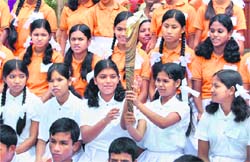 Children hold the Queens Baton for the CWG at an orphanage in Agartala on Saturday. 
