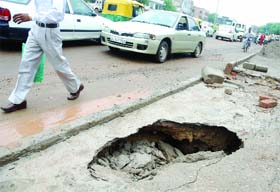 A portion of a newly-built footpath on Aurobindo Road in New Delhi caved in