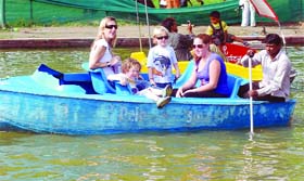 Foreigners enjoy boating at the India Gate