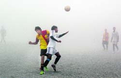 A match of the 39th Jackie Invitational Soccer Tournament being played amid thick fog in Mussoorie on Sunday. 