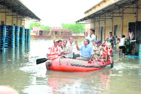 Finance Secretary (Agriculture) clicks a picture from his mobile as he takes a boat ride to the HSWC storehouse at Bani village in Sirsa