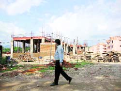 A man passes by an under-construction hospital