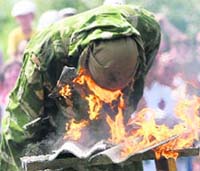 A soldier from Ukranian airborne troops smashes his head into burning asbestos sheets during a show marking the forces' annual holiday in the town of Zhytomyr on Sunday. The holiday for airborne troops, which is celebrated on August 2, began during the Soviet era and continues till today.
