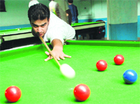 Ankur Nanda aims a shot during the Haryana State Billiards and Snooker Championship in Panchkula on Monday. Tribune photo: Nitin Mittal