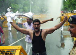 Police uses water cannons to disperse BJP activists holding a protest against the alleged financial irregularities in CWG preparations at Jantar Mantar in New Delhi on Monday.
