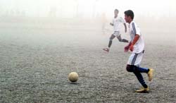 Thick fog shrouds the ground during the 39th Jackie Invitational Soccer Tournament in Dehradun on Monday.