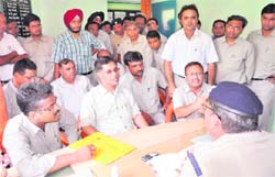 BHEL Executive Engineers talk to the SHO of the Ranipur police station in Haridwar on Monday. 