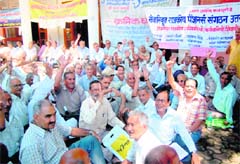 State government pensioners hold a demonstration at the District Collectorate in Dehradun on Monday. 
