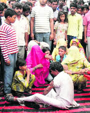 Women on dharna outside the police station with the victim and his wailing children at Kulan in Fatehabad.