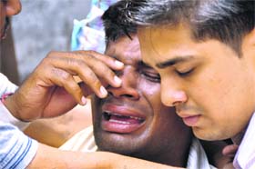 Bunty, brother of the accident victim Sumit Gupta, wails near the mishap site in Ludhiana