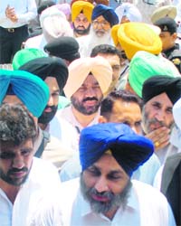 Punjab Chief Minister Parkash Singh Badal and Deputy Chief Minister Sukhbir Singh Badal come out of the Mohali District Courts