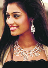 Neha Hinge, Miss India International 2010, showcases a jewellery collection during the inauguration of a jewellery showroom in Bangalore on Tuesday.