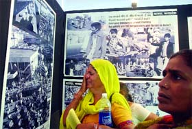 A woman breaks down as she looks at a photograph of Bhopal gas victims at an exhibition on the gas tragedy at Jantar Mantar, New Delhi, on Tuesday.