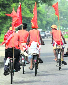Kanwariyas, ride bicycles as they proceed to carry holy water of the Ganga to perform abhishek of Lord Shiva, in Meerut