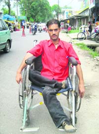 Bir Singh on his wheelchair in Kangra in search of a job