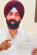 Bholath MLA Sukhpal Singh Khaira shows a document