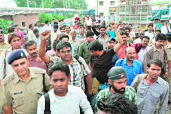 Northern Railway employees return to Jammu-Tawi railway station on Tuesday in the wake of continuing violence in the Kashmir