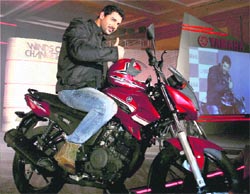 Actor John Abraham, brand ambassador of Yamaha, poses with a new motorcycle of the company at its launch in Greater Noida on Wednesday.