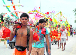 Devotees carrying kanwars pass through the National Highway 8 in Gurgaon 