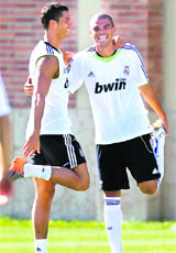 Real Madrids Cristiano Ronaldo (L) and Pepe stretch during training in Los Angeles on Wednesday.