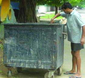 An eyewitness shows the dustbin where an infant girl was found dead in New Delhi