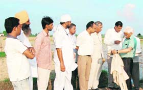 Commissioner Balbir Singh Malik verifies figures of the special girdawari at Panihari village in Sirsa