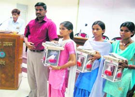 The ADC of Jind with girl students holding solar lamps at a function at Jind