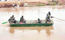 Armymen on a rescue mission in a flood-hit Sirsa village.