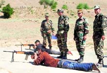 Children get training in small arms firing at a camp organised by the Army