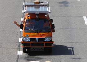 Crew members sit inside an Electric Piaggio Porter, made by The Artificial Vision and Intelligent Systems Laboratory (VisLab) of Parma University, as it is driven by a computer, in Kiev on August 4, 2010