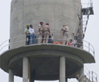 The volunteers of AIE scheme along with the cops at the overhead water tank in village Lakho Ke Behram of Ferozepur