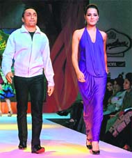 Bollywood actors Rahul Bose and Celina Jaitley walk the ramp to showcase the creation of Malini Ramani at a fashion show in Kolkata late on Thursday.