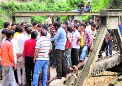 Lakhwar Byasi Dam Sangharsh Samiti members block a bridge in Mussoorie on Friday