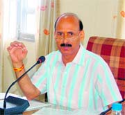 IPH minister Ravinder Ravi hints at giving a clean chit to HPCC chief Kaul Singh at a press conference at Dharamsala on Friday.